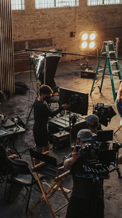 A film set with monitors, booms, and multiple setups.